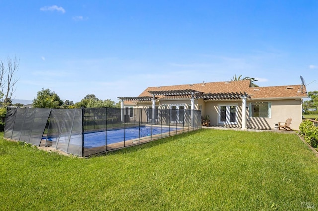 back of house featuring fence, a pergola, stucco siding, a fenced in pool, and a lawn