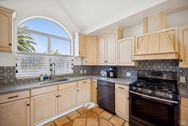 kitchen with light brown cabinets, custom range hood, a sink, appliances with stainless steel finishes, and vaulted ceiling