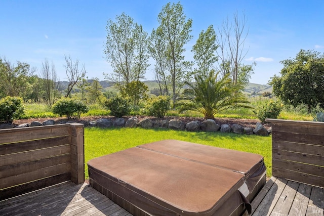 wooden deck with a lawn and hot tub deck surround