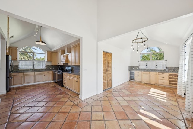kitchen with backsplash, light brown cabinetry, black appliances, and a healthy amount of sunlight