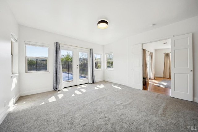 interior space featuring french doors, carpet, baseboards, and access to exterior