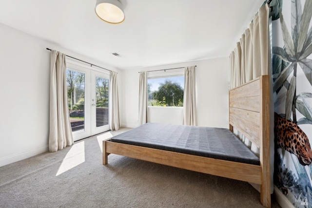 carpeted bedroom with access to outside, baseboards, visible vents, and french doors