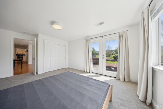unfurnished bedroom with french doors, access to exterior, visible vents, carpet floors, and baseboards