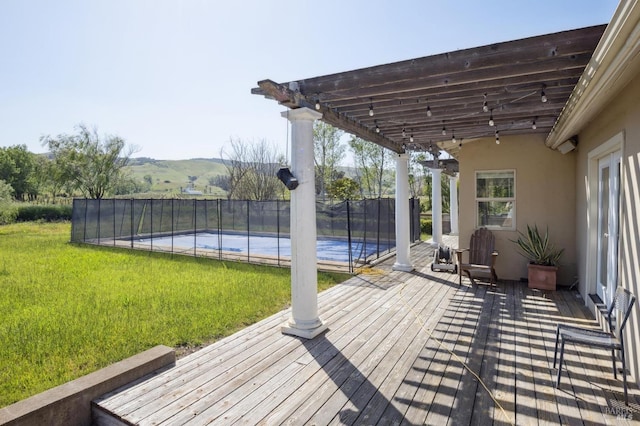 deck featuring a fenced in pool, fence, a pergola, and a yard