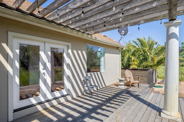 wooden terrace with french doors and a pergola