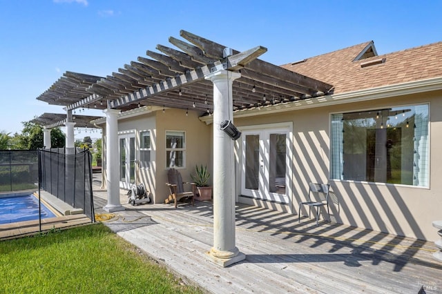rear view of property with french doors, a pergola, and stucco siding