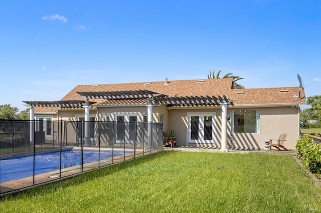 rear view of house featuring french doors, a pergola, stucco siding, and a yard