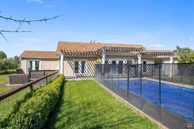 back of property featuring french doors, a lawn, a hot tub, a pergola, and stucco siding