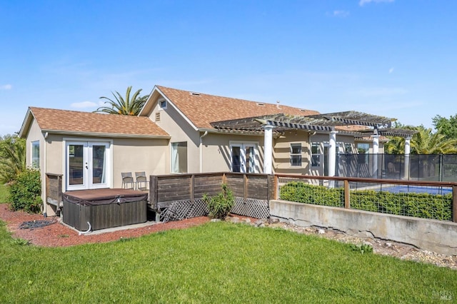 back of house with a pergola, roof with shingles, stucco siding, french doors, and a hot tub