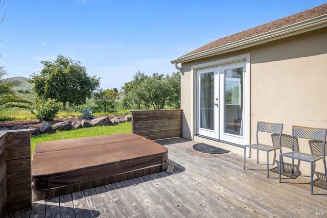 wooden deck featuring french doors and a covered hot tub