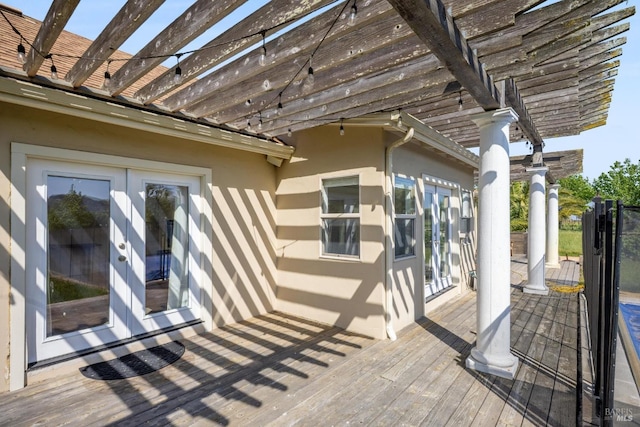 deck featuring french doors and a pergola