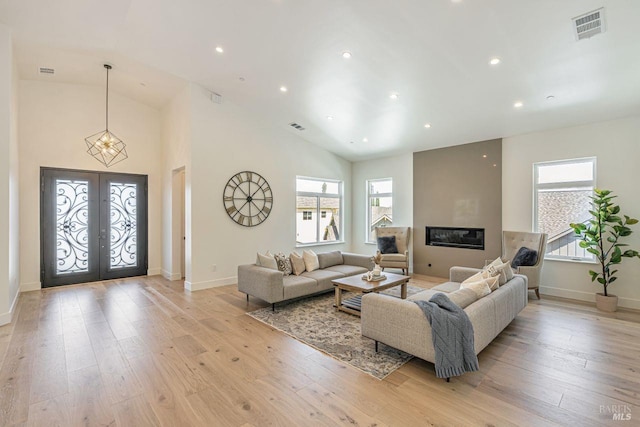living area with recessed lighting, baseboards, visible vents, and light wood finished floors