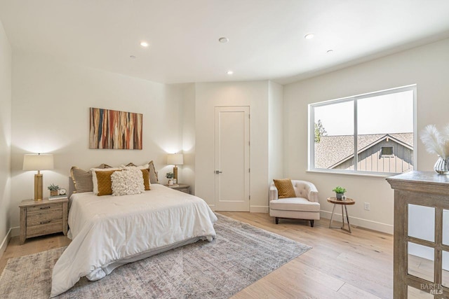 bedroom with recessed lighting, baseboards, and light wood finished floors