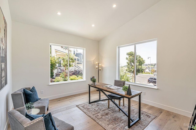 office area featuring recessed lighting, light wood-style flooring, baseboards, and vaulted ceiling