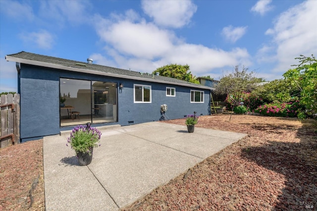 back of house featuring stucco siding, a patio area, and fence