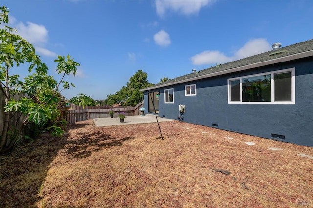 rear view of property with a patio, a fenced backyard, stucco siding, and crawl space