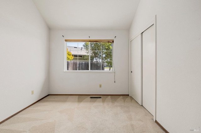 unfurnished bedroom featuring visible vents, carpet flooring, and baseboards