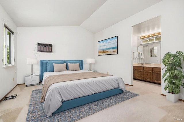 bedroom with a wall mounted AC, light carpet, ensuite bathroom, and vaulted ceiling