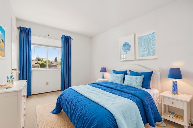 bedroom featuring baseboards and light colored carpet