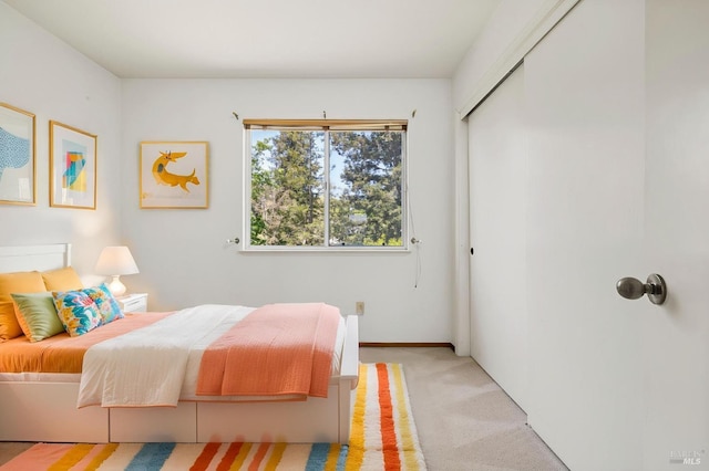 bedroom with light carpet and a closet