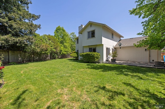 view of yard featuring fence and a patio