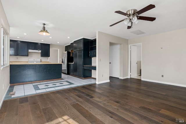 unfurnished living room with baseboards, ceiling fan, and wood finished floors