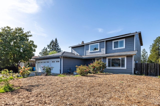 traditional-style home with an attached garage and fence