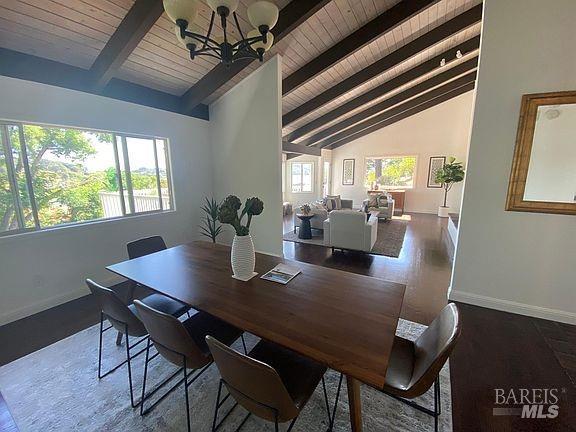 15 Main Dr, San Rafael, CA 94901 - dining space with baseboards, a notable chandelier, wooden ceiling, and vaulted ceiling with beams