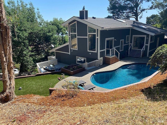 15 Main Dr, San Rafael, CA 94901 - back of house featuring a deck, an outdoor pool, a yard, entry steps, and a chimney