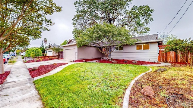 ranch-style home featuring fence, an attached garage, concrete driveway, and a front lawn