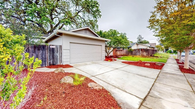 view of front facade featuring stucco siding, driveway, and fence