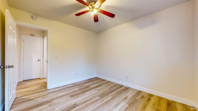 unfurnished room with baseboards, ceiling fan, and light wood-style flooring