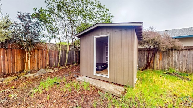 view of shed with a fenced backyard
