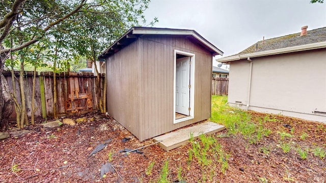 view of shed featuring fence