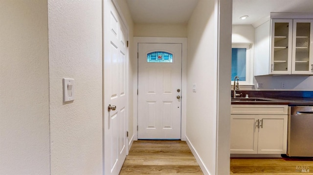 doorway featuring light wood-style floors and a sink