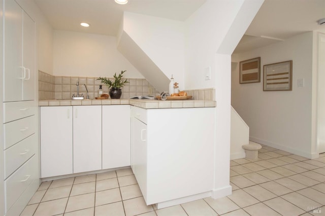 45 Laurel Grove Ave, Kentfield, CA 94904 - kitchen featuring tile countertops, a sink, light tile patterned floors, recessed lighting, and white cabinetry