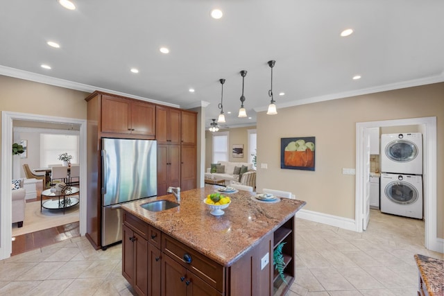 190 Franklin St, Napa, CA 94558 - kitchen with stainless steel fridge, estacked washer and dryer, a sink, crown molding, and light tile patterned floors