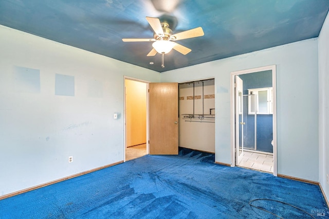 unfurnished bedroom featuring ceiling fan, carpet floors, baseboards, ensuite bathroom, and a closet