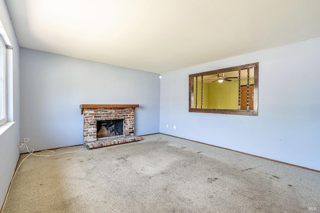 unfurnished living room featuring a fireplace, baseboards, carpet, and a ceiling fan