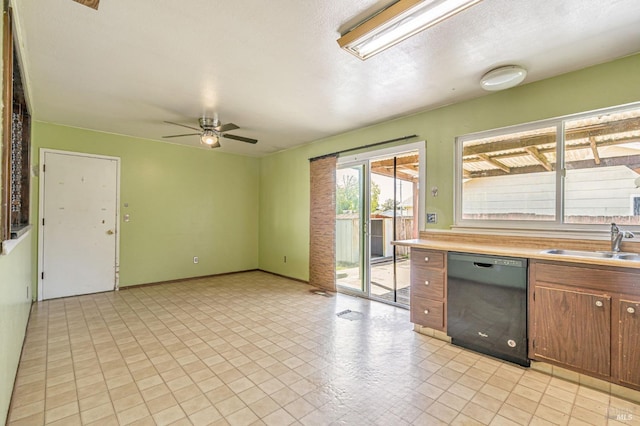 interior space with a ceiling fan, light countertops, brown cabinets, a sink, and dishwasher