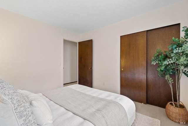 carpeted bedroom with a closet