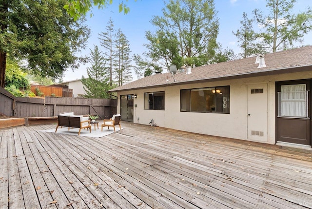 wooden terrace with fence and an outdoor living space