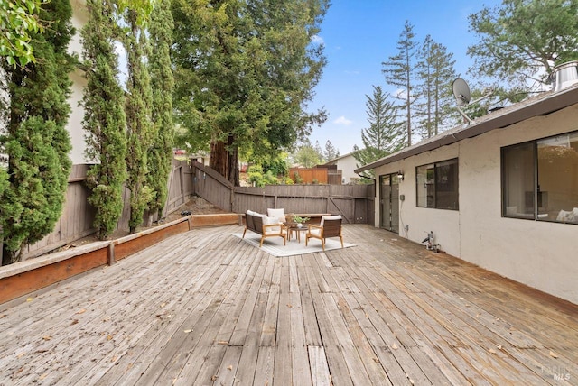deck featuring a fenced backyard and an outdoor hangout area