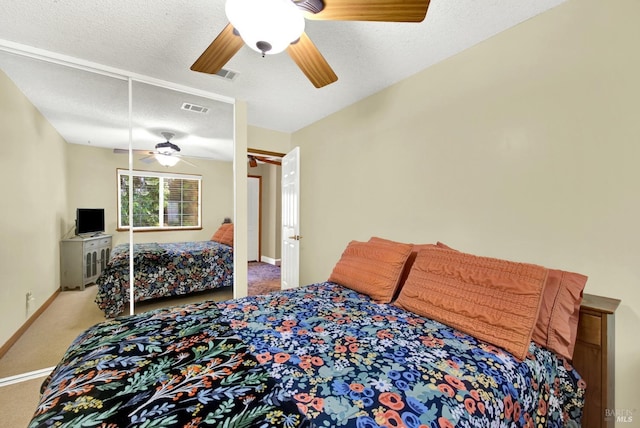 bedroom with ceiling fan, visible vents, baseboards, and carpet