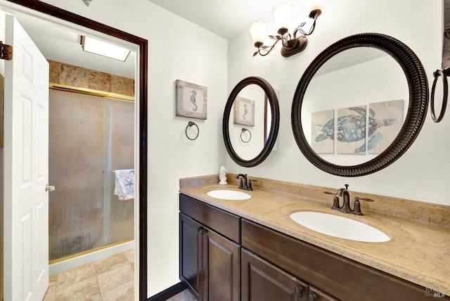 full bathroom featuring a sink, a stall shower, and double vanity