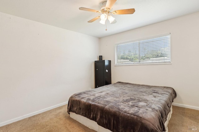 bedroom featuring carpet floors, baseboards, and a ceiling fan