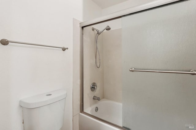 full bath with bath / shower combo with glass door and toilet
