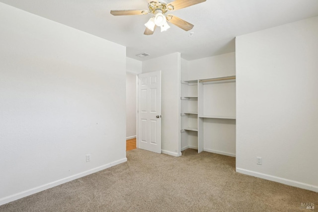 unfurnished bedroom featuring baseboards, ceiling fan, carpet, and visible vents