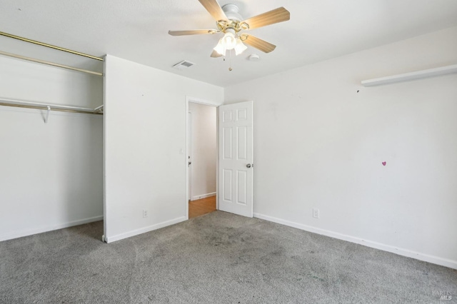 unfurnished bedroom with visible vents, a closet, baseboards, ceiling fan, and carpet flooring