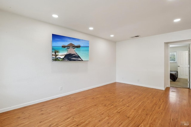unfurnished room with recessed lighting, baseboards, visible vents, and wood finished floors